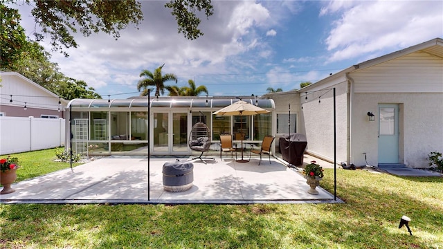 1849 Del Robles Dr, Clearwater, FL 33764 - back of house with fence, stucco siding, a sunroom, a patio area, and a yard