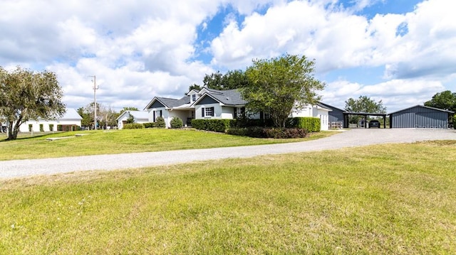 view of front facade with a front yard and gravel driveway
