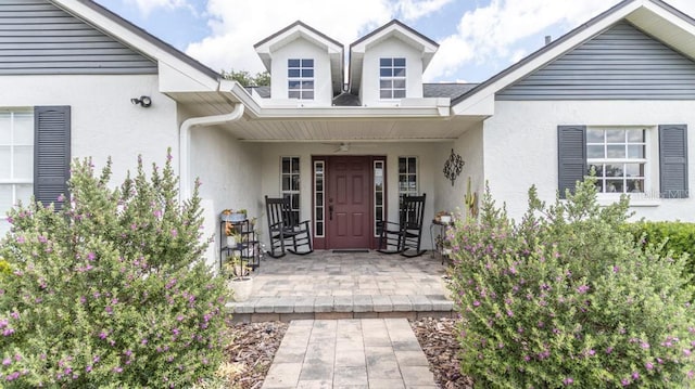 property entrance with stucco siding
