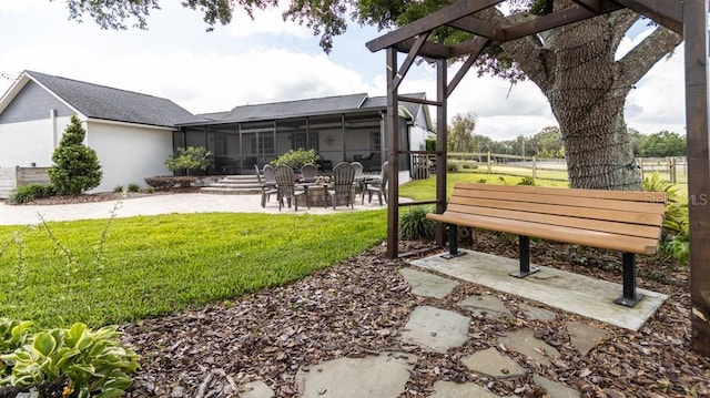 view of community featuring a yard, fence, and a patio area