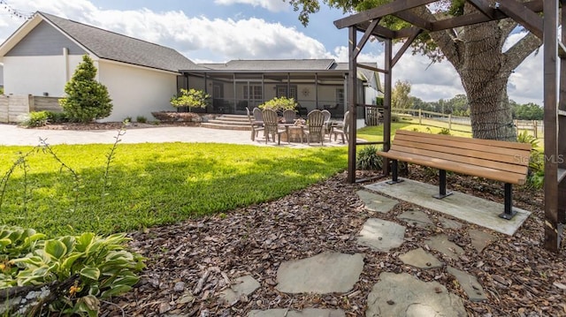 view of yard with a sunroom, a patio area, fence, and a pergola