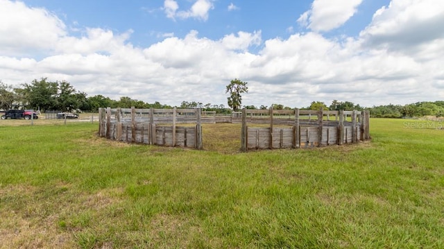 view of yard featuring a rural view and fence