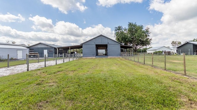exterior space with driveway, an outbuilding, an exterior structure, an outdoor structure, and an attached carport