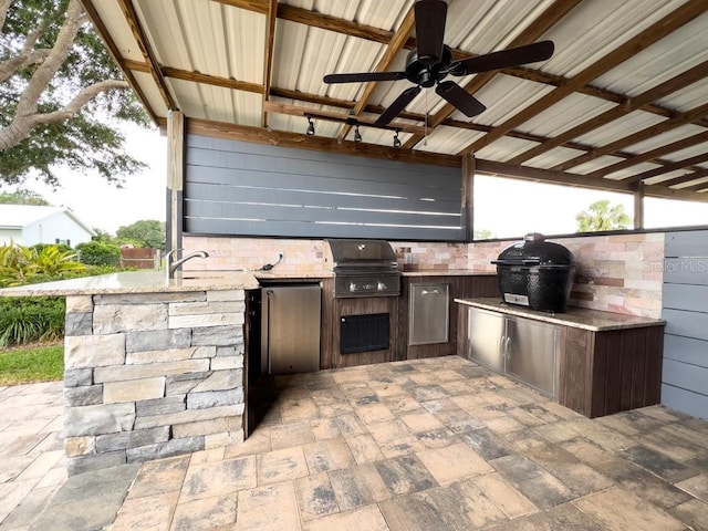 view of patio with area for grilling, exterior kitchen, ceiling fan, and a sink