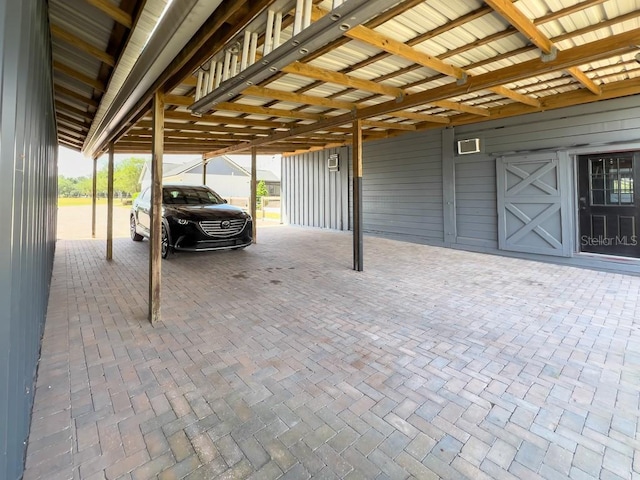 view of parking / parking lot with visible vents