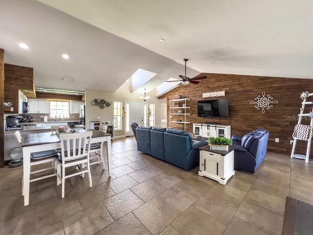 living room featuring recessed lighting, ceiling fan, vaulted ceiling, and wood walls