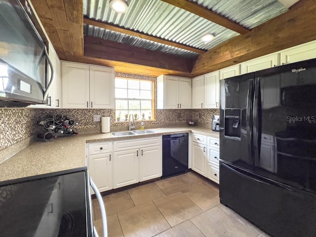 kitchen with tile patterned flooring, decorative backsplash, white cabinets, and black appliances