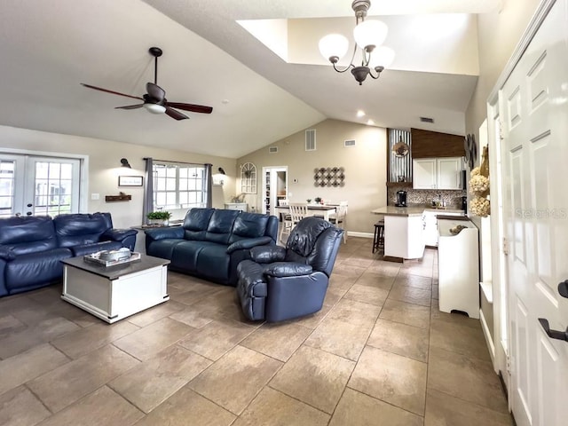 living room with visible vents, ceiling fan with notable chandelier, and lofted ceiling