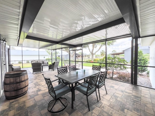 sunroom / solarium featuring outdoor dining space and outdoor lounge area