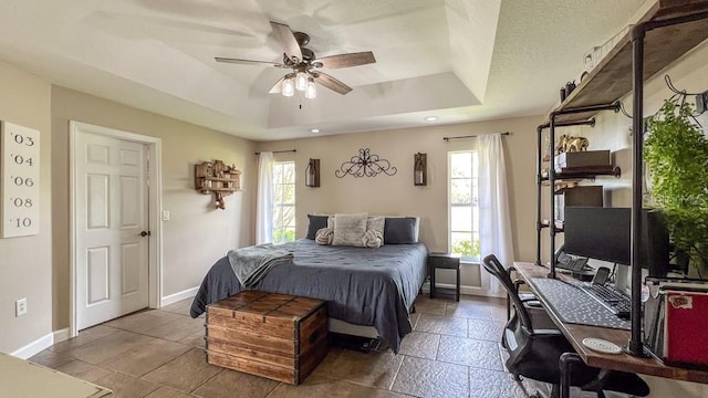bedroom featuring baseboards, a ceiling fan, a tray ceiling, and recessed lighting