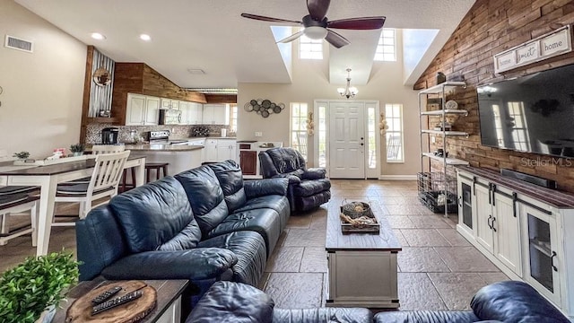 living area with visible vents, ceiling fan, a healthy amount of sunlight, and high vaulted ceiling