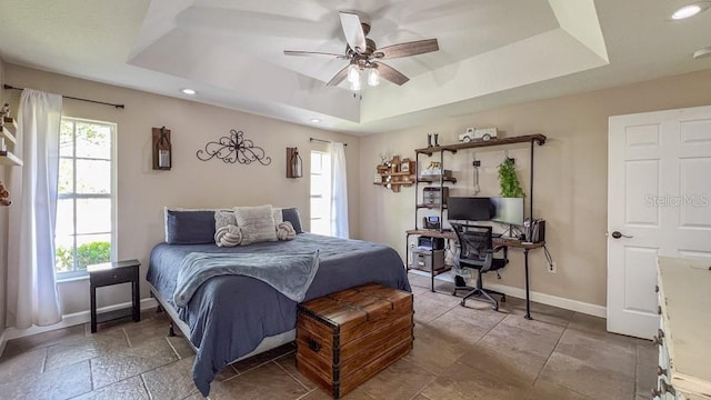 bedroom with baseboards, a ceiling fan, a tray ceiling, and recessed lighting