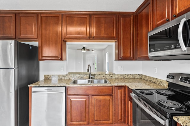 1506 Lenton Rose Ct, Trinity, FL 34655 - kitchen with stainless steel appliances, a ceiling fan, light stone counters, and a sink