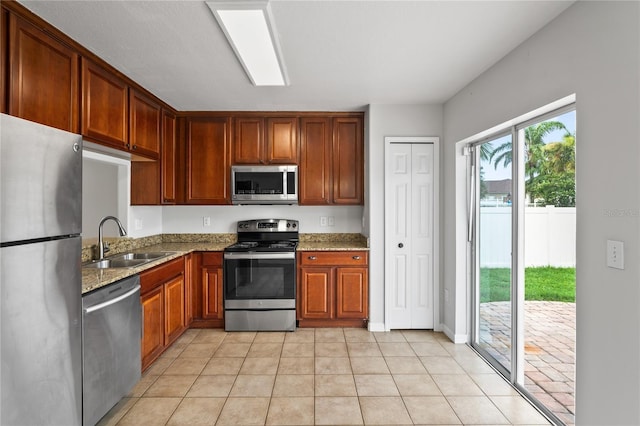1506 Lenton Rose Ct, Trinity, FL 34655 - kitchen with a sink, light stone counters, light tile patterned floors, and stainless steel appliances