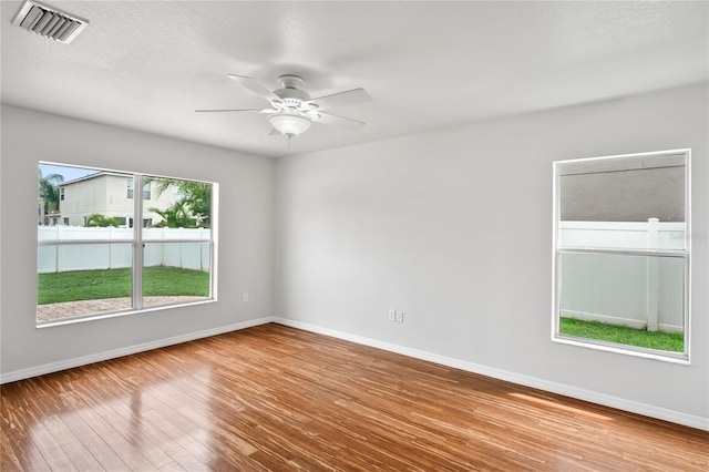 1506 Lenton Rose Ct, Trinity, FL 34655 - empty room featuring visible vents, baseboards, and wood finished floors