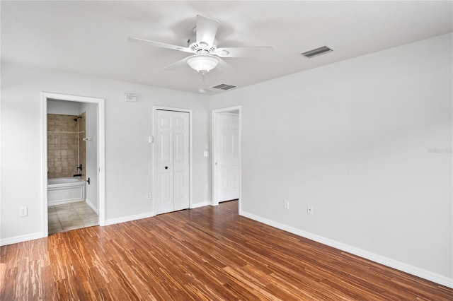 1506 Lenton Rose Ct, Trinity, FL 34655 - unfurnished bedroom with baseboards, visible vents, and wood finished floors