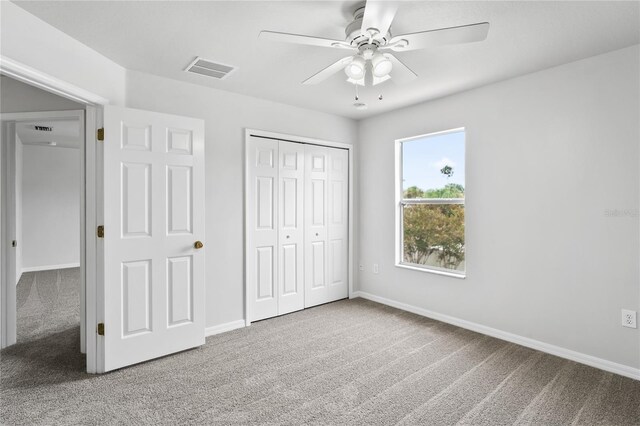 1506 Lenton Rose Ct, Trinity, FL 34655 - unfurnished bedroom with carpet floors, visible vents, a closet, baseboards, and ceiling fan