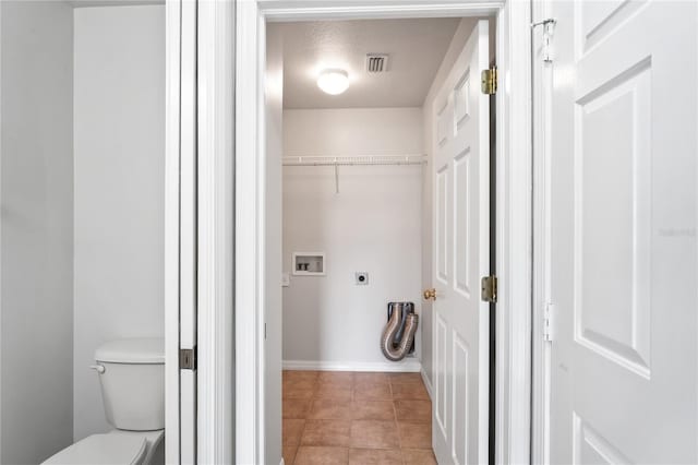 1506 Lenton Rose Ct, Trinity, FL 34655 - bathroom with visible vents, toilet, baseboards, a walk in closet, and tile patterned floors