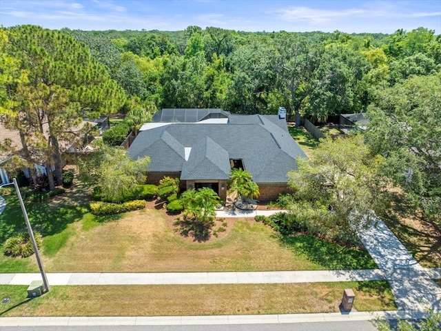 drone / aerial view featuring a view of trees
