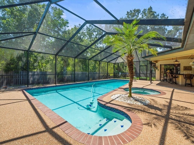 view of swimming pool with an in ground hot tub, a patio area, glass enclosure, a fenced in pool, and a fenced backyard