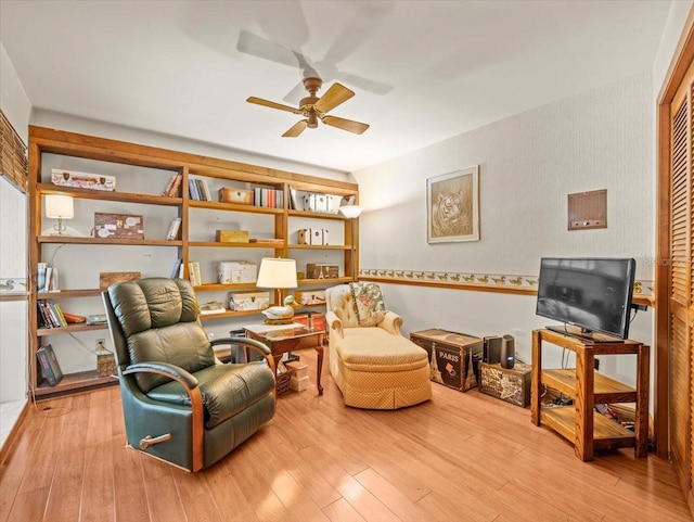 sitting room featuring ceiling fan and wood finished floors