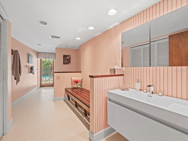 interior space with visible vents, baseboards, tile patterned floors, wallpapered walls, and recessed lighting