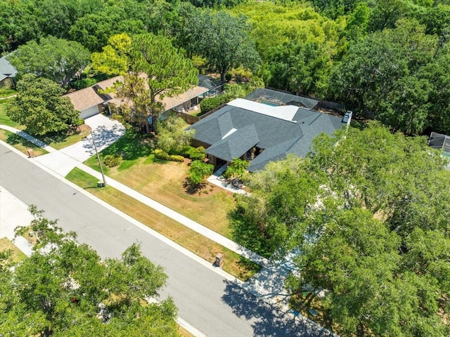 birds eye view of property featuring a view of trees