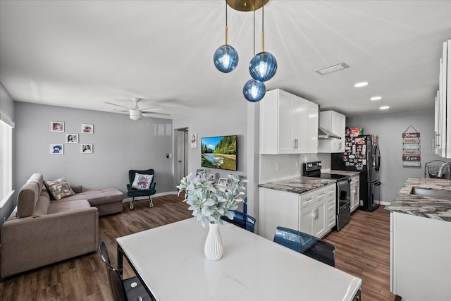 kitchen featuring dark wood finished floors, a sink, open floor plan, stainless steel electric stove, and white cabinetry