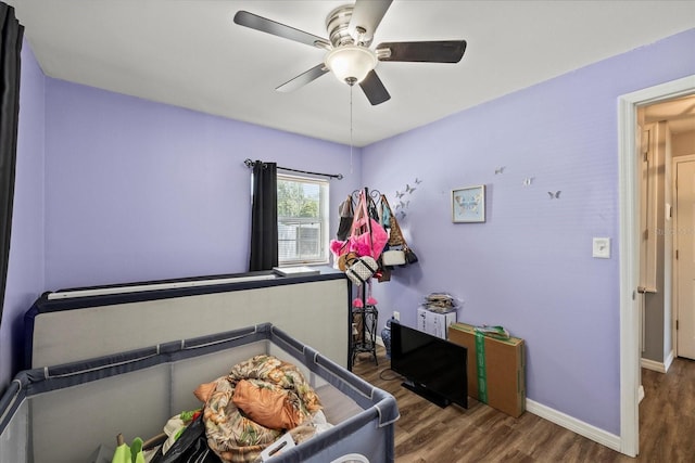 bedroom featuring baseboards, a ceiling fan, and wood finished floors