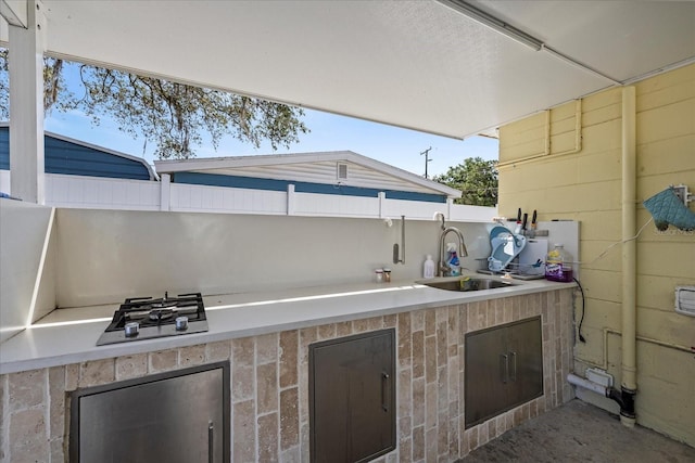 view of patio featuring exterior kitchen and a sink