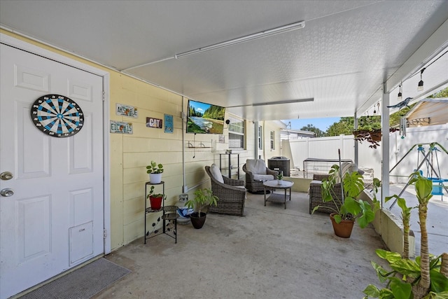 view of patio with fence and an outdoor hangout area
