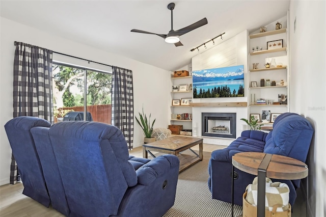 1502 Creekbend Dr, Brandon, FL 33510 - living room featuring a ceiling fan, a fireplace with raised hearth, light wood-style flooring, and lofted ceiling
