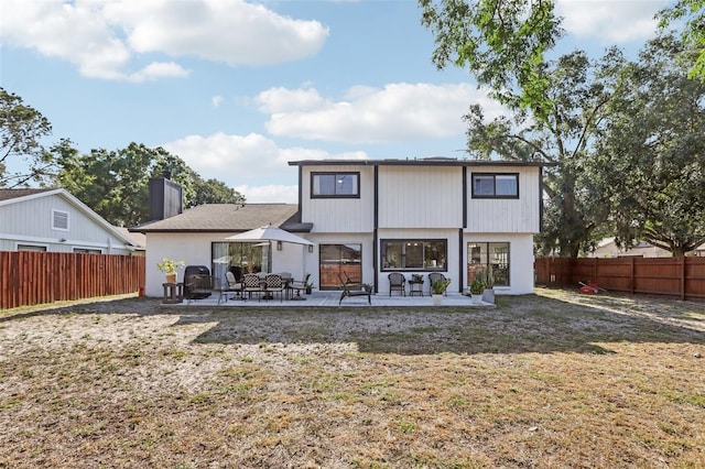 1502 Creekbend Dr, Brandon, FL 33510 - back of house with a fenced backyard, a patio area, a yard, and a chimney