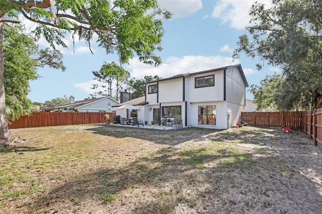 1502 Creekbend Dr, Brandon, FL 33510 - back of house featuring a fenced backyard, a patio, and a yard
