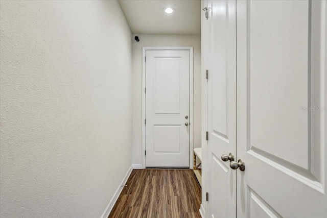 hallway with recessed lighting, baseboards, and dark wood-style floors