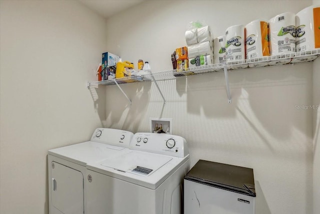 clothes washing area with laundry area and washer and clothes dryer