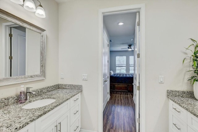 bathroom featuring vanity, a ceiling fan, ensuite bath, and wood finished floors