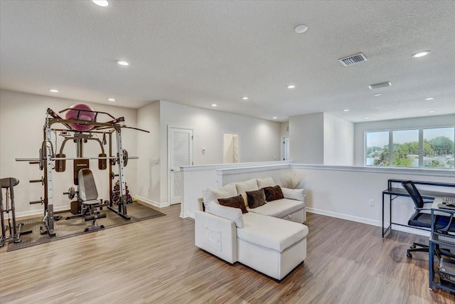 interior space with visible vents, recessed lighting, baseboards, and wood finished floors