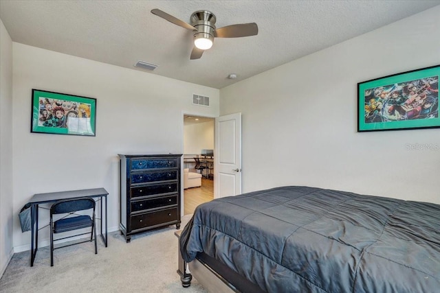 bedroom with light colored carpet, ceiling fan, visible vents, and baseboards