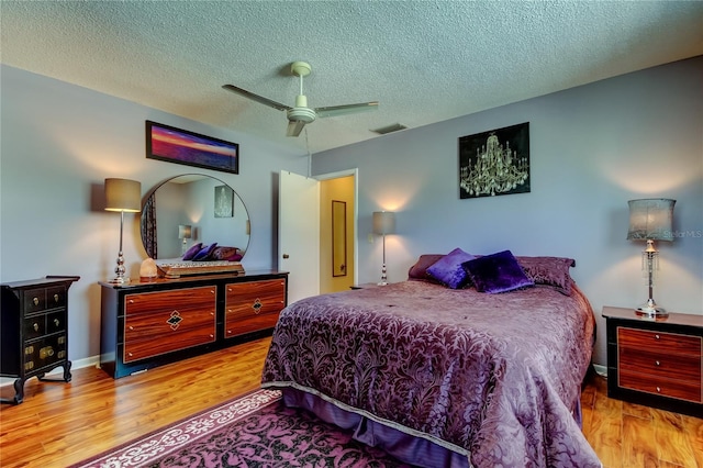 2600 Forest Run Ct, Clearwater, FL 33761 - bedroom featuring wood finished floors, a textured ceiling, a ceiling fan, and baseboards