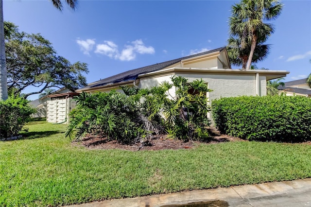 2600 Forest Run Ct, Clearwater, FL 33761 - view of side of property with stucco siding and a yard