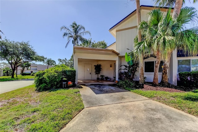2600 Forest Run Ct, Clearwater, FL 33761 - view of front of house featuring concrete driveway, a front lawn, and stucco siding