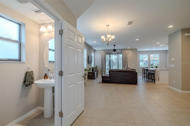 interior space with light tile patterned floors, baseboards, recessed lighting, and visible vents