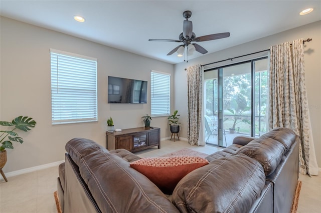 living area with light tile patterned floors, baseboards, a ceiling fan, and recessed lighting