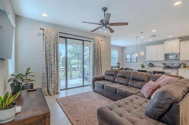 living room with a ceiling fan, recessed lighting, light tile patterned flooring, and visible vents