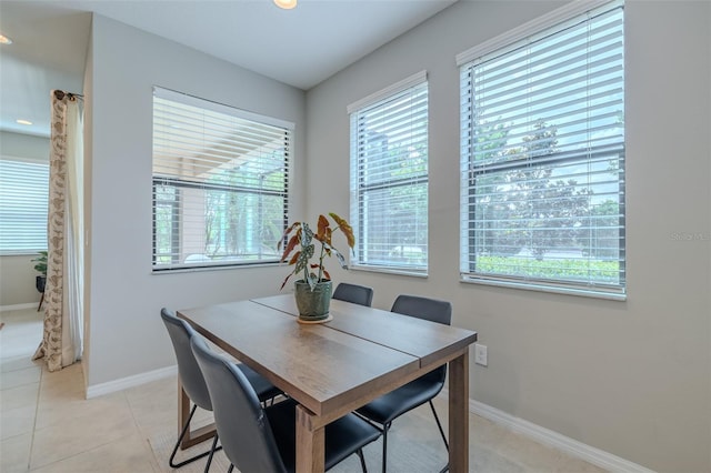 dining space featuring recessed lighting, baseboards, light tile patterned flooring, and a wealth of natural light