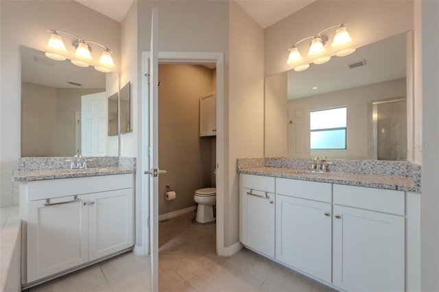 full bath featuring visible vents, a sink, and two vanities