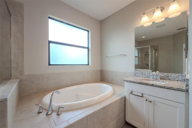 bathroom featuring vanity, a bath, visible vents, and a shower stall