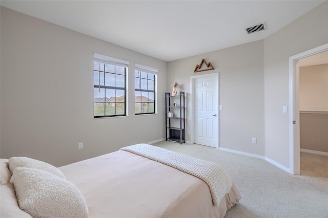 bedroom featuring visible vents, carpet, and baseboards