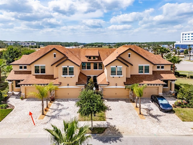 view of front of property featuring a garage, driveway, and stucco siding